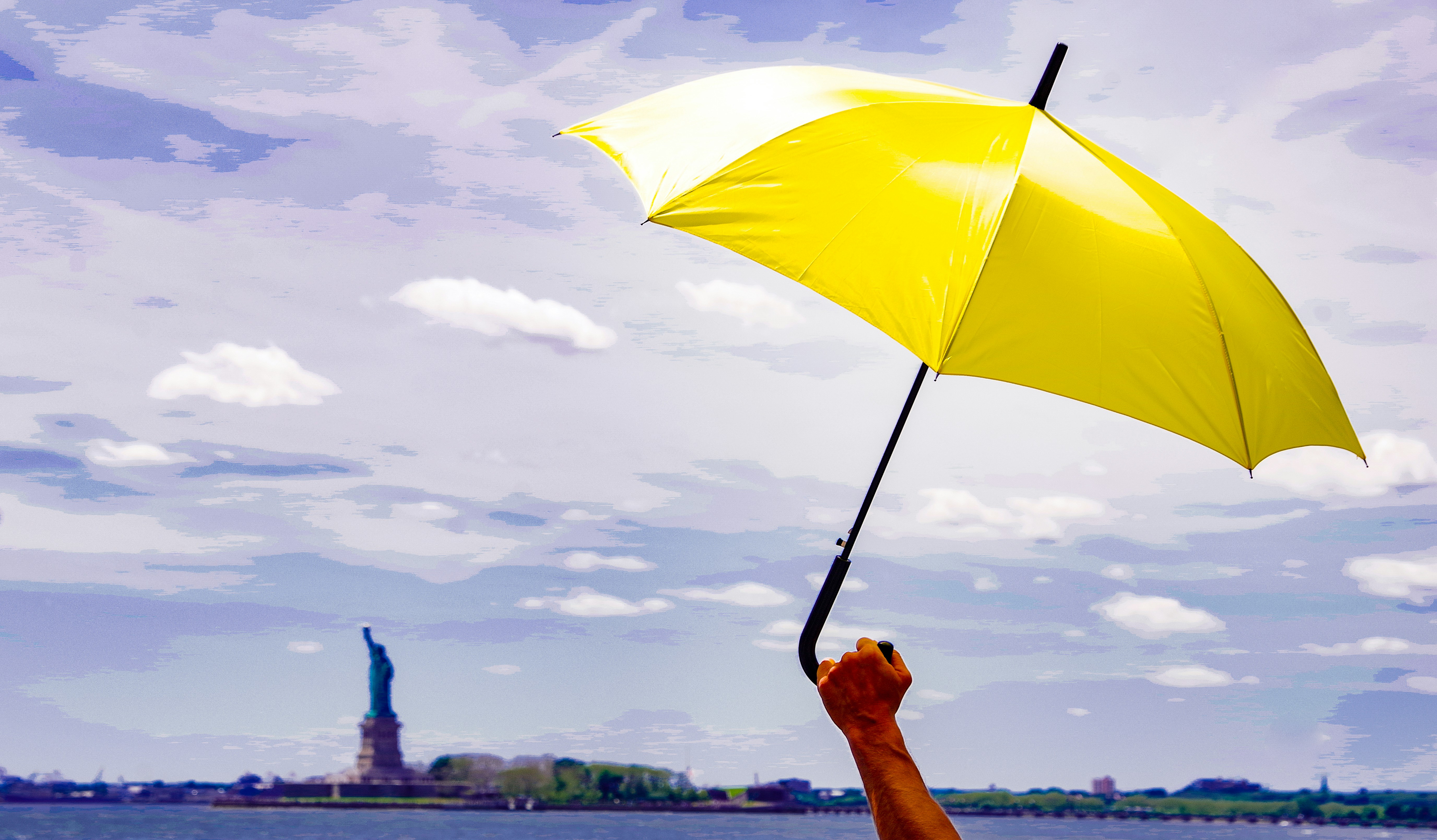 Yellow umbrella as seen from Governor's Island looking toward the Statue of Liberty.